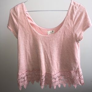 Pink cropped shirt with lace detail.